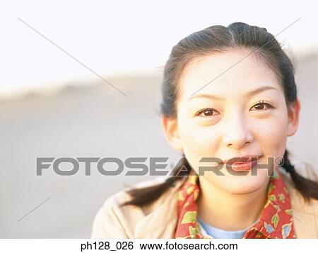 Stock Photograph - Portrait of a young Asian woman . Fotosearch