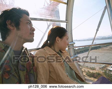 Stock Photograph - Portrait of Young couple looking away. Fotosearch