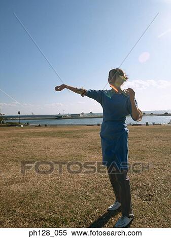 Stock Photography - Silhouette a young woman standing . Fotosearch