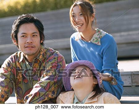 Three friends sitting on steps, smiling View Large Photo Image Stock Photo - Three friends sitting on steps, smiling. Fotosearch