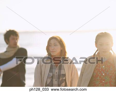 Three people at the beach View Large Photo Image Stock Image - Three people at the beach. Fotosearch