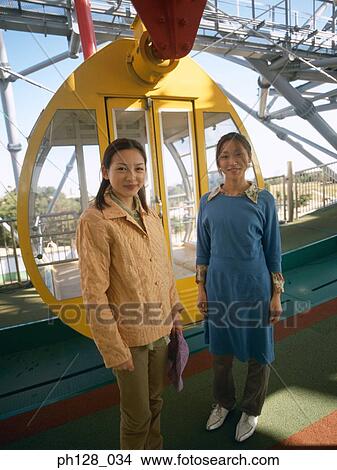 Two women at Ferris wheel entrance View Large Photo Image Picture - Two women at Ferris wheel entrance. Fotosearch