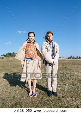 Stock Image - Two young women standing . Fotosearch