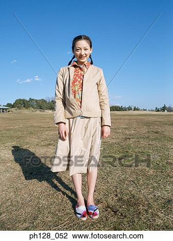 Stock Image - Two young women standing . Fotosearch