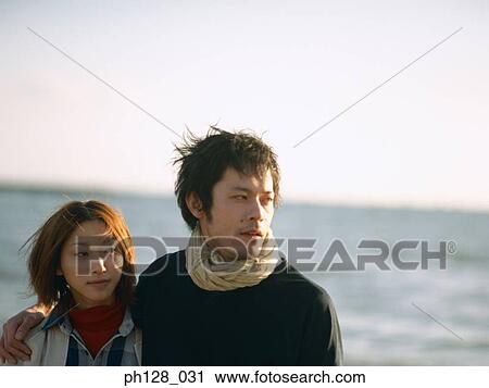Stock Image - Young couple at the beach. Fotosearch