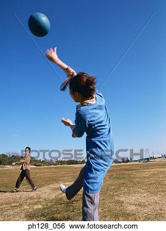 Stock Photograph - Young couple playing ball games. Fotosearch