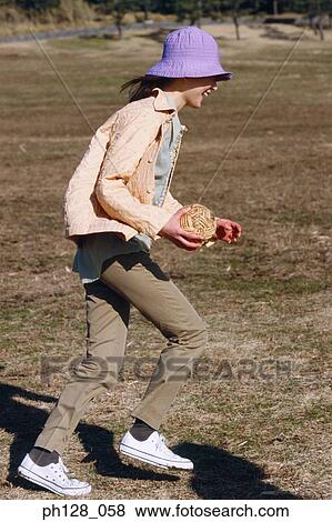 Young girl with a ball in her hands, running View Large Photo Image Stock Photo - Young girl with a ball in her hands, running. Fotosearch