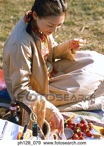 Young woman spreading jam on biscuit View Large Photo Image Stock Photo - Young woman spreading jam on biscuit. Fotosearch
