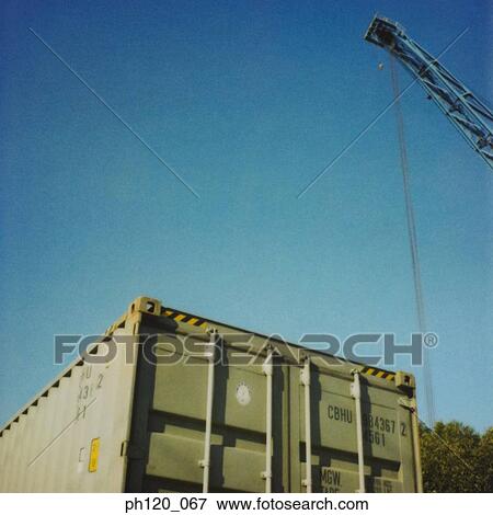 Stock Photo - Cargo and crane, low angle view. Fotosearch