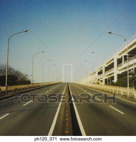 Stock Image - Empty road and street lamps. Fotosearch
