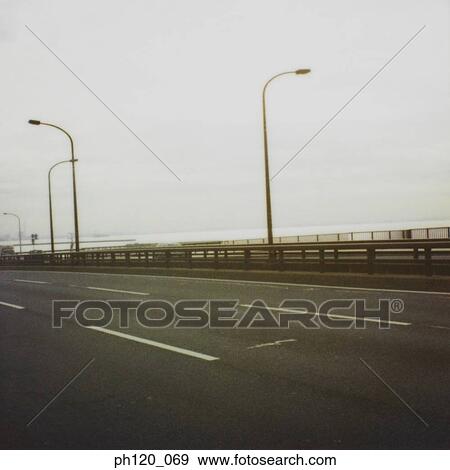 Empty road and street lamps View Large Photo Image Stock Photo - Empty road and street lamps. Fotosearch