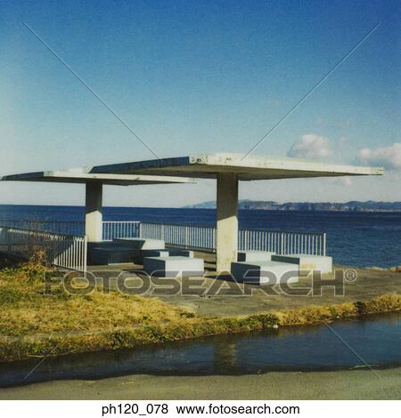 Stock Photo - Shelter and sitting area by the sea. Fotosearch