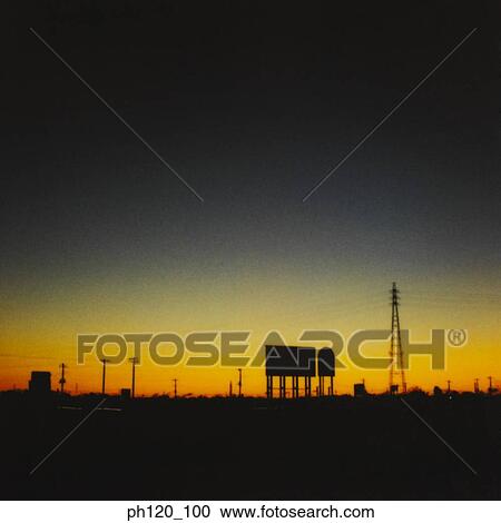 Stock Image - Silhouette view of an isolated area at sunset. Fotosearch