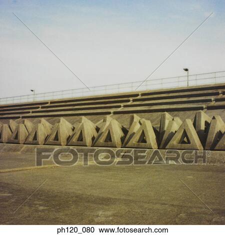 Stock Image - Stacked triangular cement blocks. Fotosearch