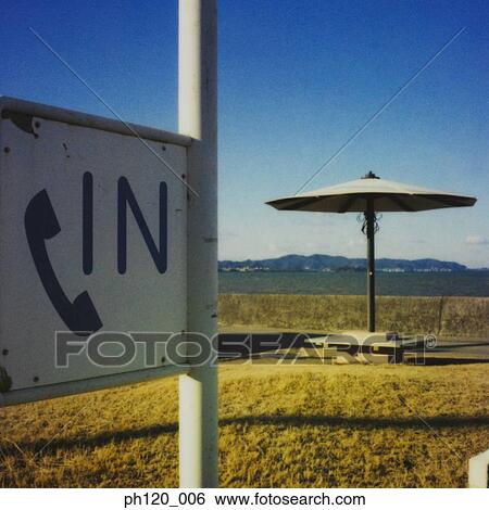 Thatch umbrella on beach, phone in signboard View Large Photo Image Stock Photograph - Thatch umbrella on beach, phone in signboard. Fotosearch