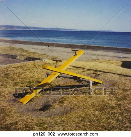 Stock Image - Two seesaws by the beach. Fotosearch