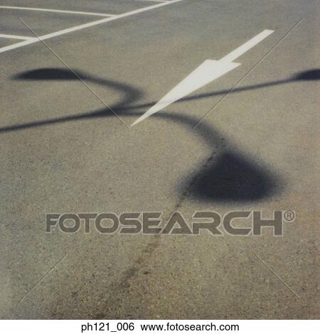 Stock Photograph - Arrow road marking on road, close-up. Fotosearch