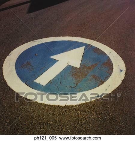 Stock Photography - Arrow road marking on road, close-up. Fotosearch