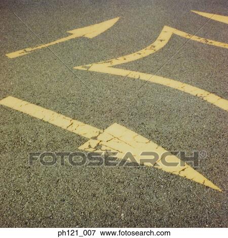 Stock Photo - Arrow road markings on road, close-up. Fotosearch
