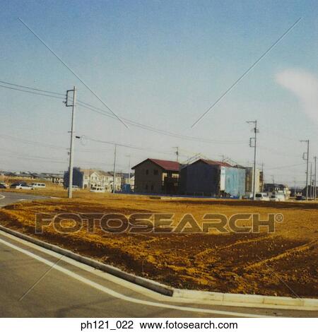 Stock Image - Empty land in residential estate. Fotosearch