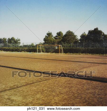 Stock Image - Empty soccer field with goal post. Fotosearch
