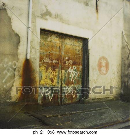 Stock Photo - Graffiti covered wall and door. Fotosearch