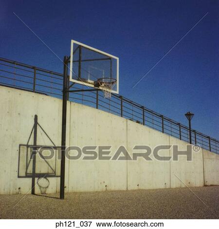 Stock Photo - Outdoor basketball hoop and court. Fotosearch