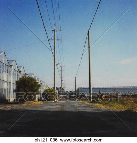 Small uneven path behind a row of houses View Large Photo Image Stock Photograph - Small uneven path behind a row of houses. Fotosearch