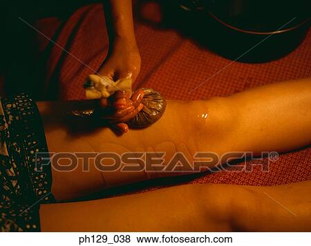 Masseuse applying essential oil therapy View Large Photo Image Stock Photo - Masseuse applying essential oil therapy. Fotosearch