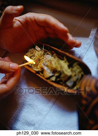 Woman lighting fire on herbs View Large Photo Image Stock Image - Woman lighting fire on herbs. Fotosearch