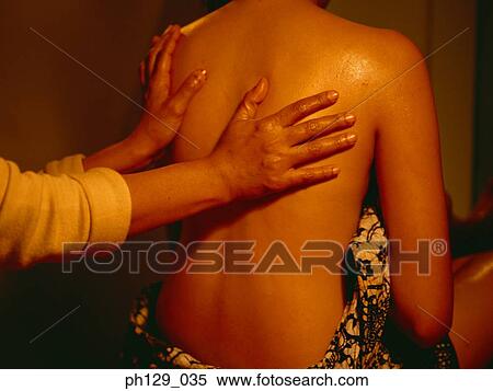 Stock Photography - Woman receiving a back massage. Fotosearch