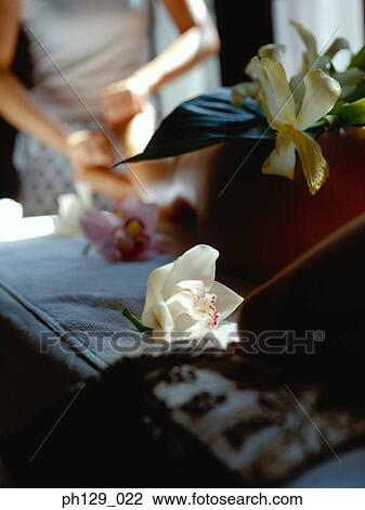 Stock Image - Woman receiving a foot massage. Fotosearch