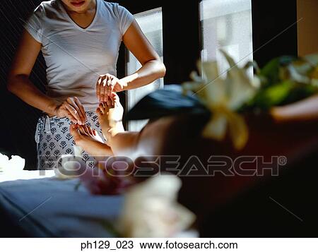 Stock Image - Woman receiving a foot massage. Fotosearch
