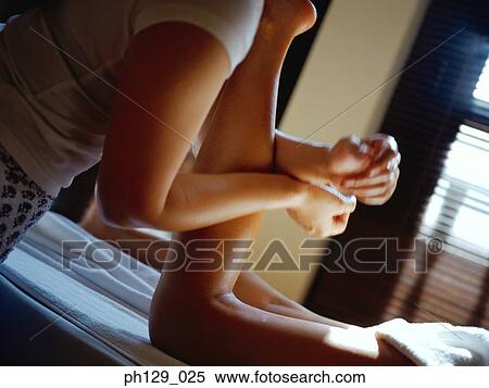Woman receiving a massage on her calf View Large Photo Image Stock Photography - Woman receiving a massage on her calf. Fotosearch
