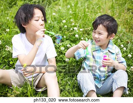 Children blowing bubbles View Large Photo Image Stock Image - Children blowing bubbles. Fotosearch