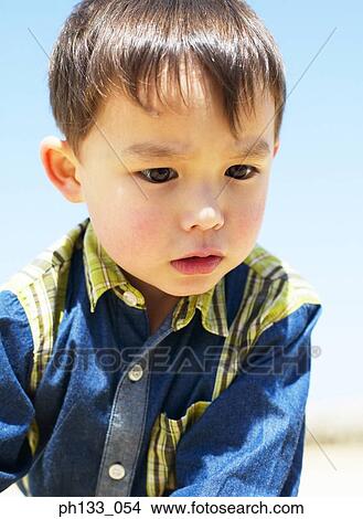 Young boy looking down View Large Photo Image Picture - Young boy looking down. Fotosearch