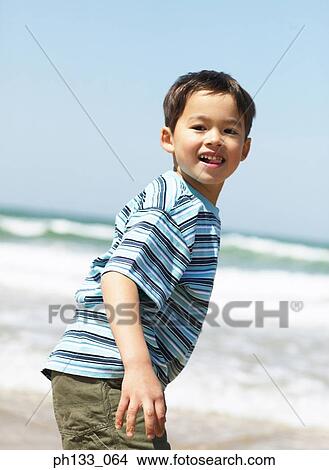 Young boy on beach View Large Photo Image Picture - Young boy on beach. Fotosearch