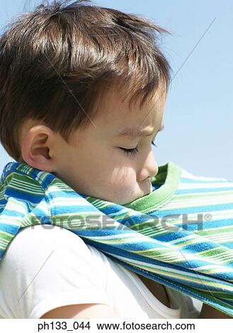 Young boy putting on a t-shirt View Large Photo Image Picture - Young boy putting on a t-shirt. Fotosearch