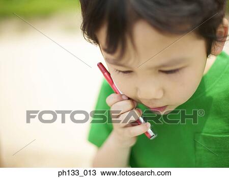 Stock Image - Young boy talking on mobile phone. Fotosearch