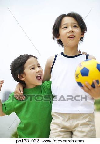 Young boys holding football and smiling View Large Photo Image Stock Image - Young boys holding football and smiling. Fotosearch