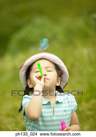 Young girl blowing bubbles View Large Photo Image Picture - Young girl blowing bubbles. Fotosearch