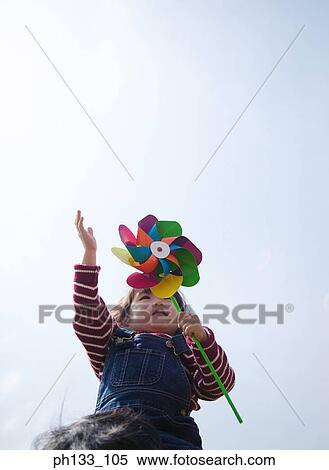 Stock Photography - Young girl playing with toy. Fotosearch