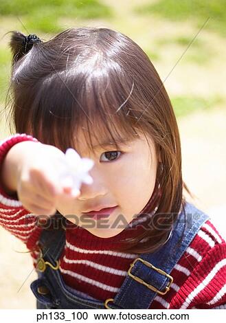 Young girl showing flower View Large Photo Image Stock Image - Young girl showing flower. Fotosearch