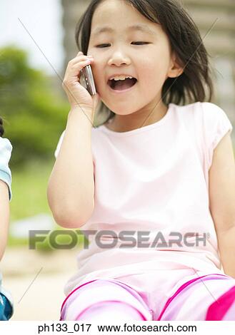 Young girl talking on mobile phone View Large Photo Image Stock Photo - Young girl talking on mobile phone. Fotosearch
