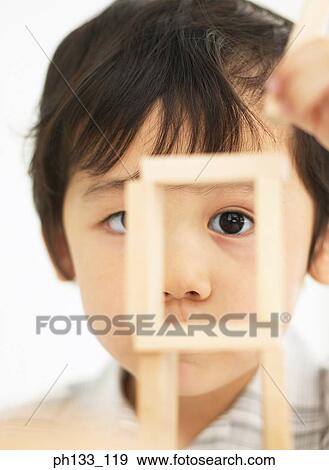 Young boy playing with wooden building blocks View Large Photo Image Stock Photo - Young boy playing with wooden building blocks. Fotosearch
