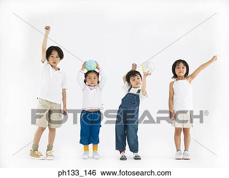 Young children standing with hands over head and smiling View Large Photo Image Stock Photograph - Young children standing with hands over head and smiling. Fotosearch