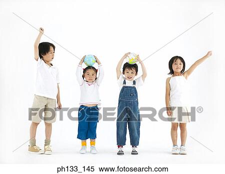 Young children standing with hands over head and smiling View Large Photo Image Stock Photography - Young children standing with hands over head and smiling. Fotosearch