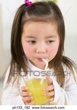Young girl drinking juice View Large Photo Image Stock Image - Young girl drinking juice. Fotosearch