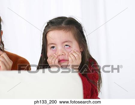 Stock Image - Young girl making face. Fotosearch
