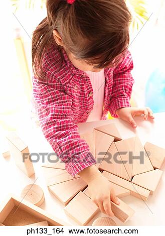 Young girl playing with wooden blocks View Large Photo Image Picture - Young girl playing with wooden blocks. Fotosearch